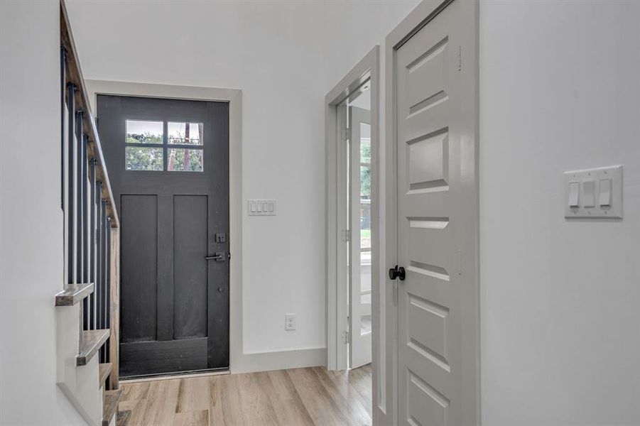 Entrance foyer with light wood-style flooring and stairway Entrance foyer with light wood-style flooring and stairway