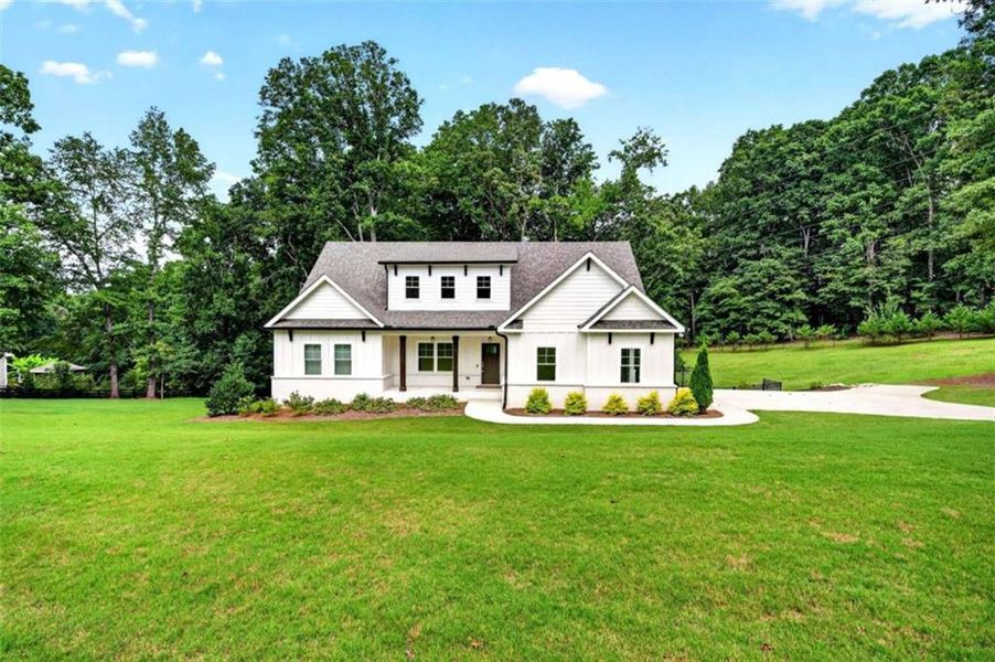 Front exterior of a new home in , Hoschton, GA, highlighting curb appeal (Image 30).