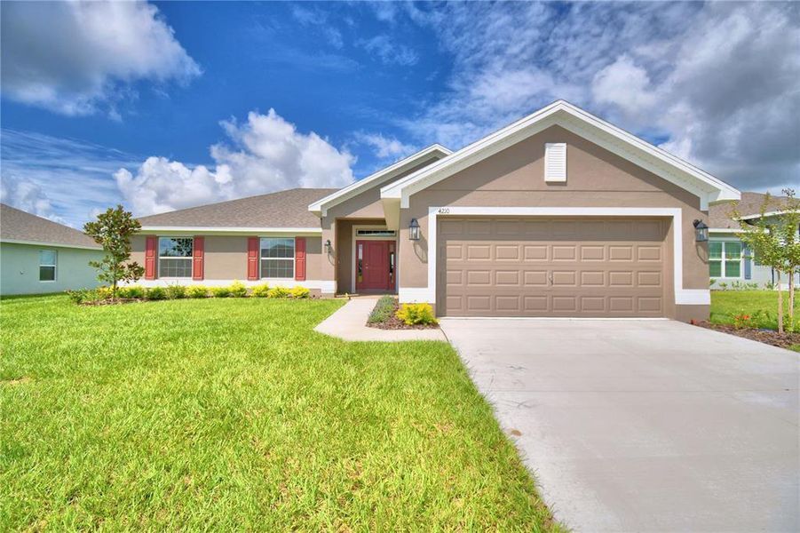 Front exterior of a new home in Cadence Crossing, Auburndale, FL, highlighting curb appeal (Image 1). Front exterior of a new home in Cadence Crossing, Auburndale, FL, highlighting curb appeal (Image 1).