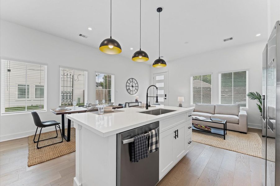 This centrally positioned kitchen island serves as a stylish anchor within the open-concept layout, offering clear sightlines to the dining area, living space, and the front yard. Its placement encourages seamless interaction, whether prepping meals or entertaining guests, while natural light pours in through the nearby windows. The island’s sleek design and functional surface make it a hub of activity, framed by elegant finishes tying together comfort and sophistication. This centrally positioned kitchen island serves as a stylish anchor within the open-concept layout, offering clear sightlines to the dining area, living space, and the front yard. Its placement encourages seamless interaction, whether prepping meals or entertaining guests, while natural light pours in through the nearby windows. The island’s sleek design and functional surface make it a hub of activity, framed by elegant finishes tying together comfort and sophistication.