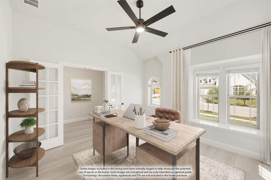 Home office with vaulted ceiling, wood desk, ceiling fan, and large windows with natural light