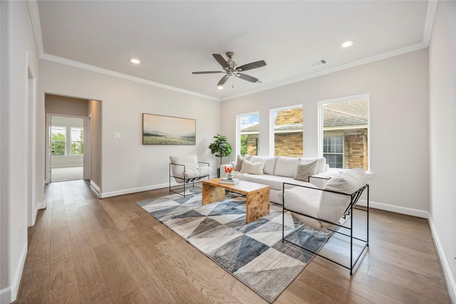 The second-story game room, a realm of leisure nestled between the serenity of the primary suite and the charm of a secondary bedroom, brightened by an expansive wall of windows.