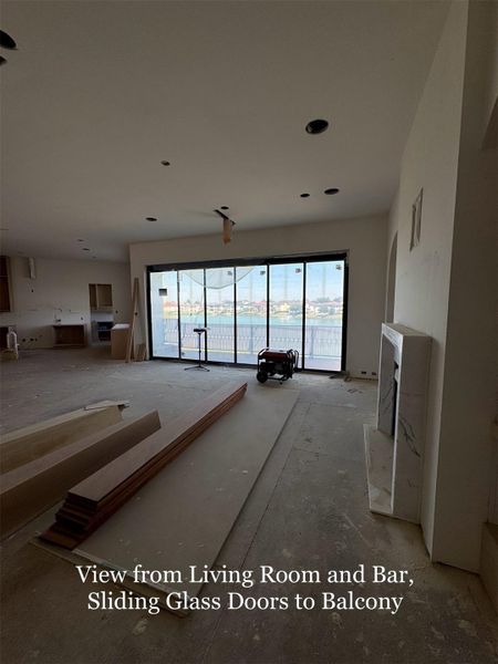 Bright and open Living space with Sliding Glass Doors that lead to a spacious Balcony overlooking the lake.