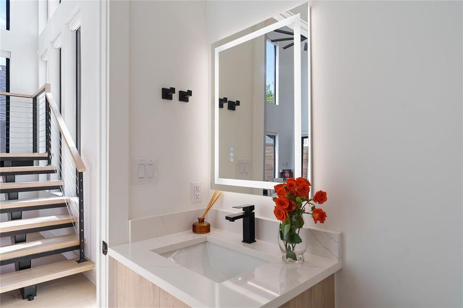 Half bathroom with front lit LED mirror