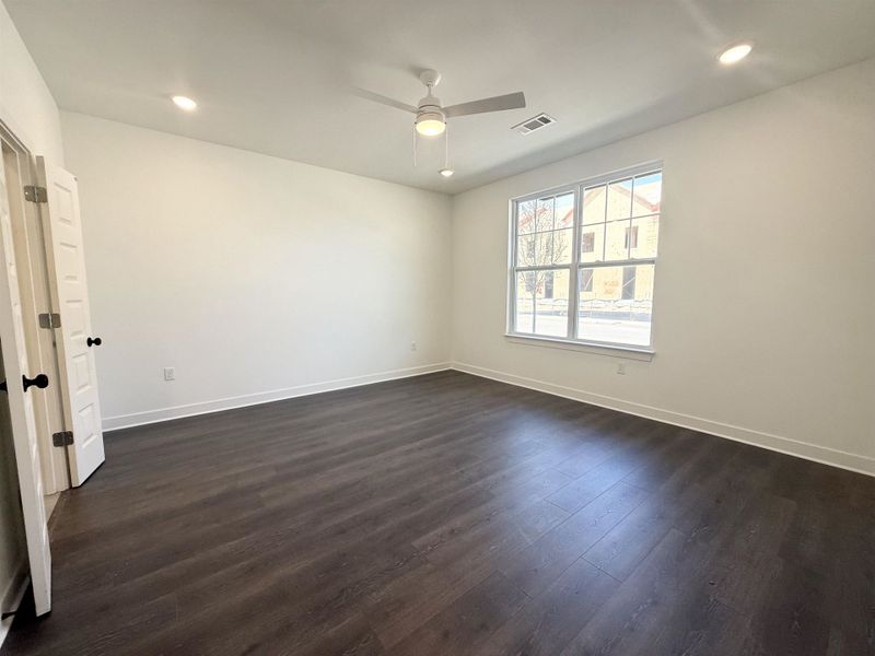 Spare room with recessed lighting, dark wood-type flooring, and a ceiling fan