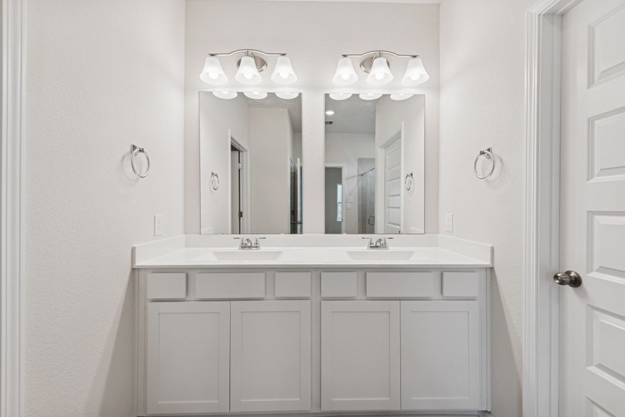 The Cardinal II- Primary Bathroom with Dual Vanities. Photos of home shown are for illustration only; actual features, colors, and upgrades may vary.