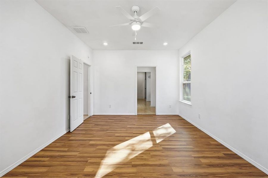 Primary bedroom featuring wood finished floors, recessed lighting, and ceiling fan