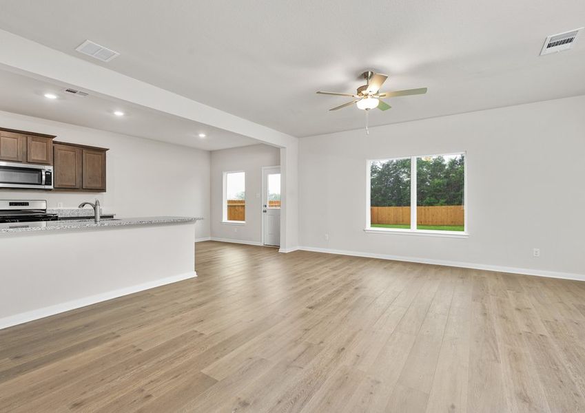 The family room sits adjacent to the kitchen and dining room. The family room sits adjacent to the kitchen and dining room.