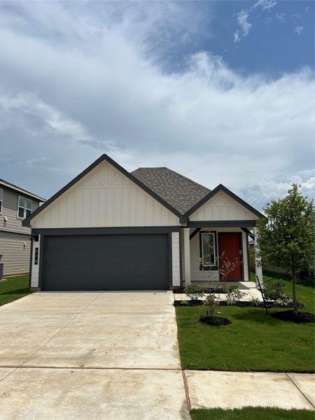 Front exterior of a new home in Cornerstone, Rockdale, TX, highlighting curb appeal (Image 1).