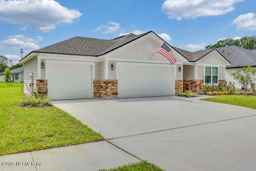 Front exterior of a new home in Edinburgh Village, Jacksonville, FL, highlighting curb appeal (Image 25). Front exterior of a new home in Edinburgh Village, Jacksonville, FL, highlighting curb appeal (Image 25).