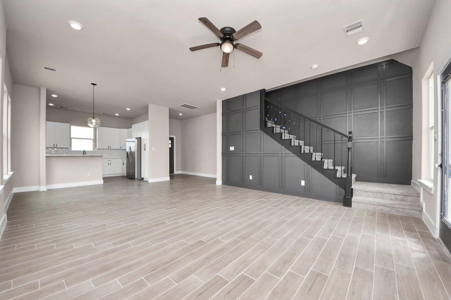 A spacious, open-concept living area with modern tile flooring and plenty of natural light. A spacious, open-concept living area with modern tile flooring and plenty of natural light.