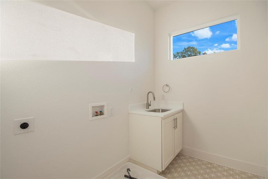 Laundry room featuring hookup for a washing machine and cabinet space