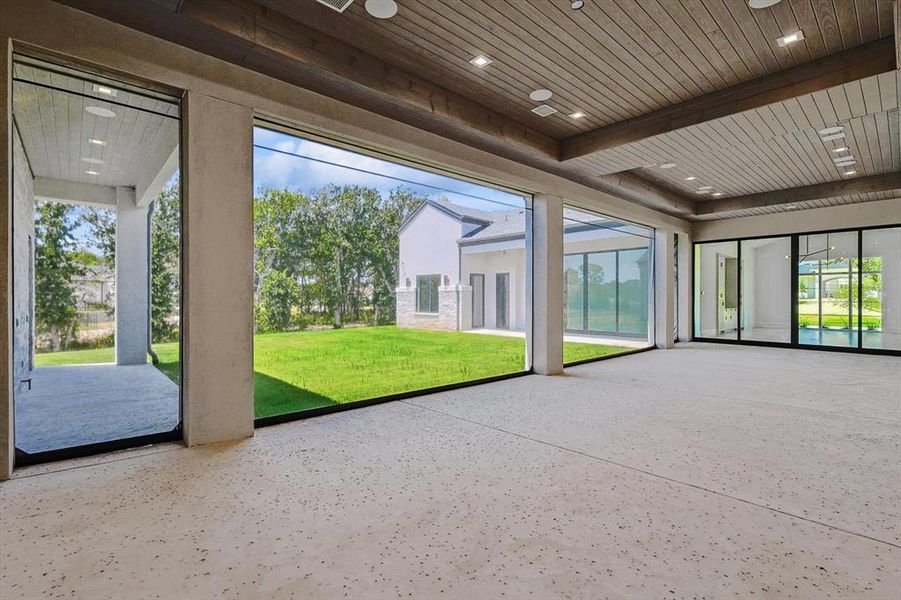 The oversized patio offers naturalized views of the acreage beyond and retractable screens to enclose the patio space.