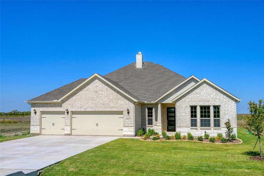 Craftsman-style house featuring a front yard and a garage