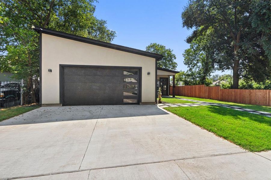 View of front facade with stucco siding and concrete driveway View of front facade with stucco siding and concrete driveway