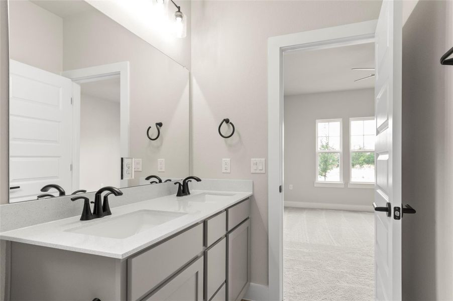 Bathroom featuring double vanity, baseboards, and ceiling fan Bathroom featuring double vanity, baseboards, and ceiling fan