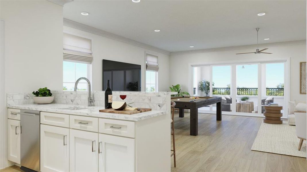 Kitchen with decorative backsplash, light stone countertops, ceiling fan, sink, and light hardwood / wood-style floors