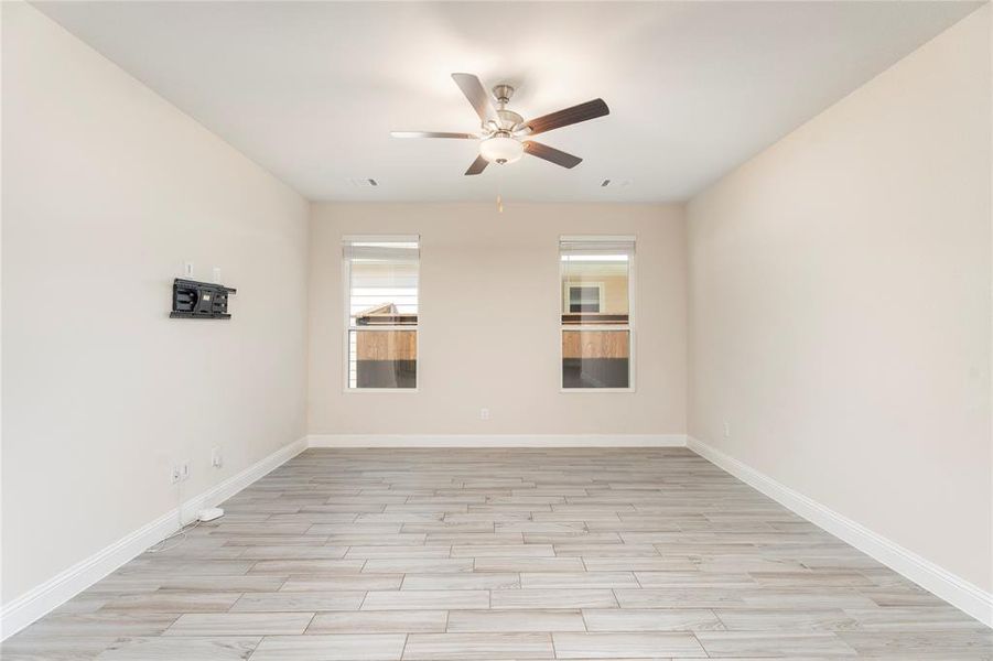 Unfurnished room featuring ceiling fan and light wood-style flooring
