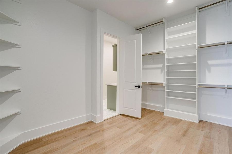 Spacious closet with light wood finished floors