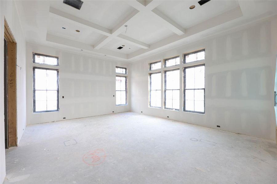 Primary Bedroom features engineered wood floors, coffered ceilings, Andersen windows, Metal frame door leading to the back patio & a masterful Primary Bathroom with over-sized shower, soak tub, 2 vanities & massive walk-in closet.