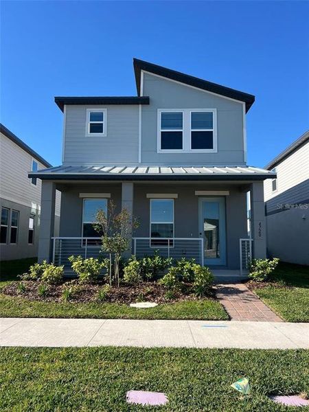 Front exterior of a new home in The Meadow at Crossprairie Bungalows, St. Cloud, FL, highlighting curb appeal (Image 1).