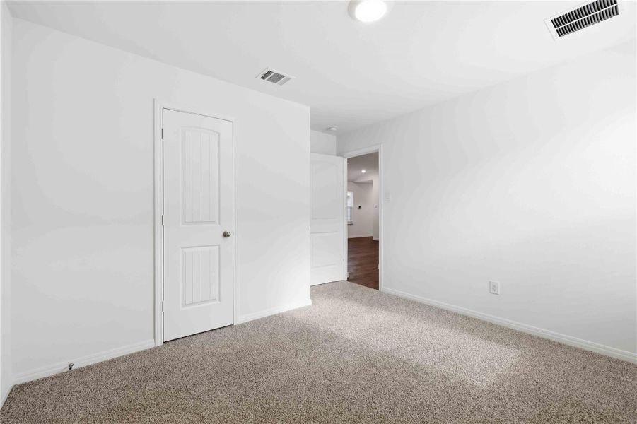One of two secondary bedrooms, both with closet storage and windows. One of two secondary bedrooms, both with closet storage and windows.
