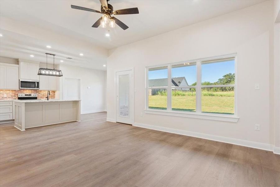 Unfurnished living room featuring recessed lighting, light wood finished floors, and a ceiling fan