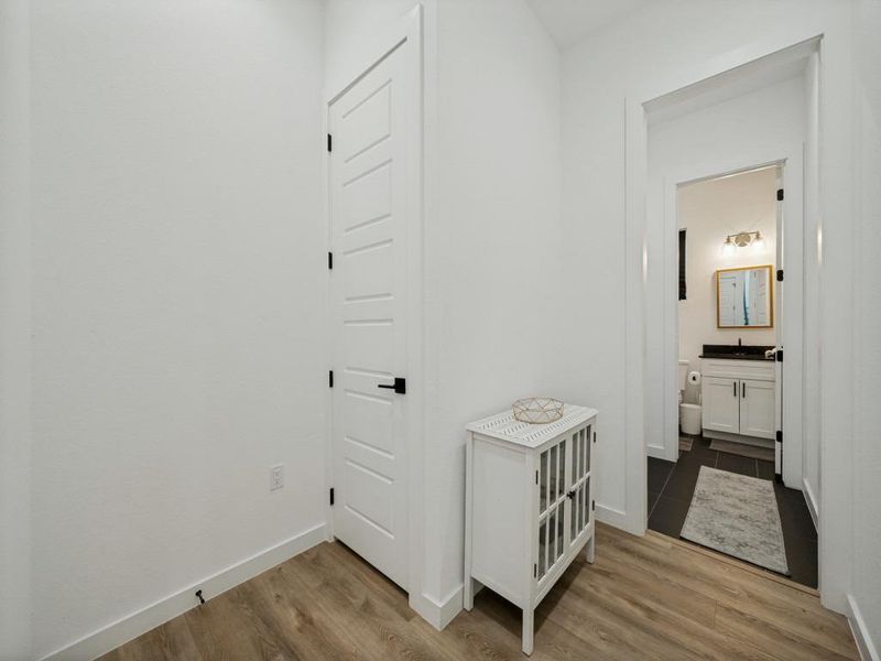 Natural wood-look flooring guides the way to a pristine full bath with sleek, modern finishes. Natural wood-look flooring guides the way to a pristine full bath with sleek, modern finishes.