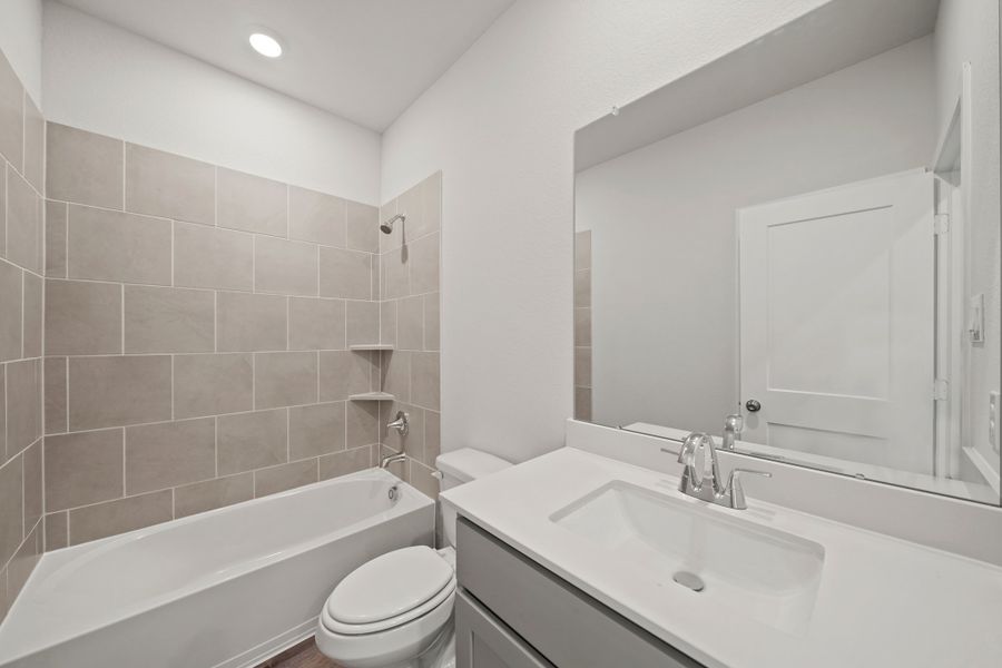 A bathroom with a tub sink and toilet. A bathroom with a tub sink and toilet.