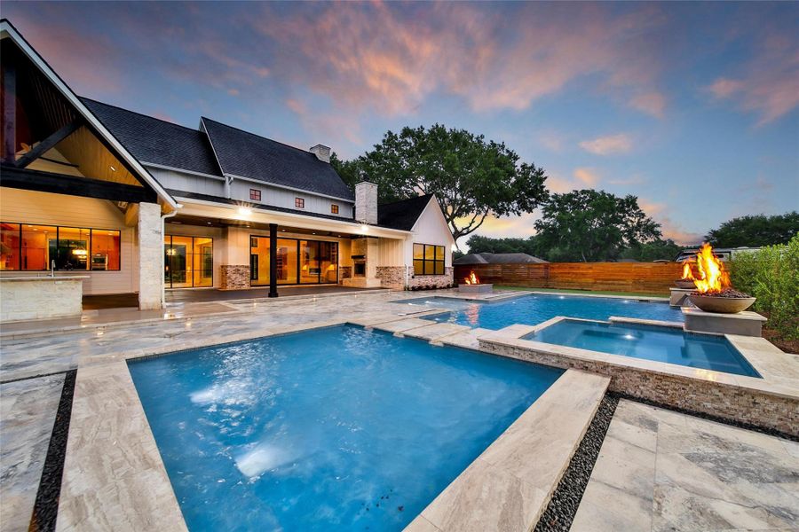 Cool off on the multi-level pool.  Surrounded by beautiful travertine tile, fire features, sunning ledge and shallow pool area is the perfect space to get that much needed Vitamin D.  Swim in the deep area for a cool plunge while enjoying the sounds of the waterfall feature.