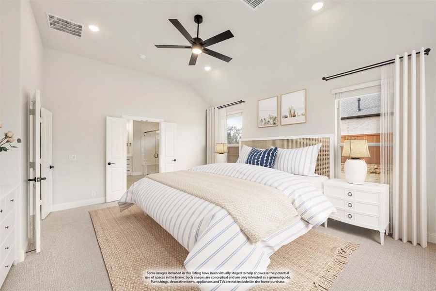 Bright master bedroom with vaulted ceiling, ceiling fan, carpet flooring, and ensuite bathroom access