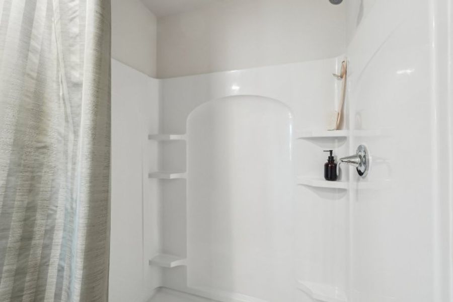 A bathroom with a shower curtain.