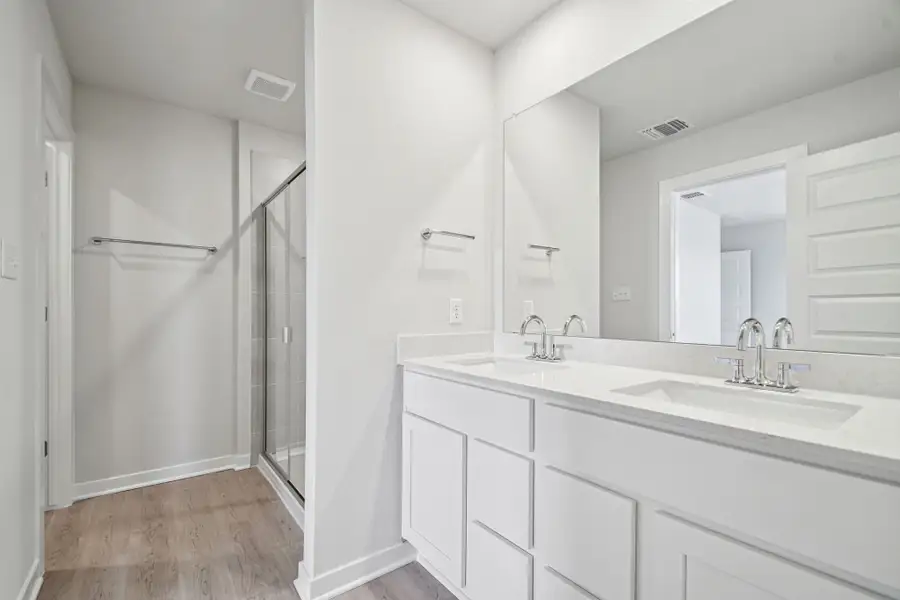 A bathroom with white cabinets.