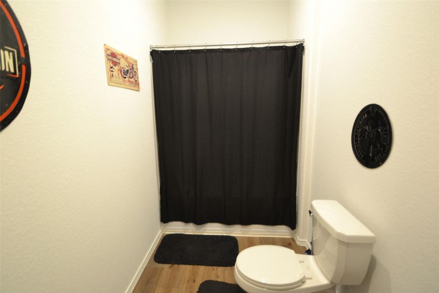 Bathroom with wood finished floors and toilet