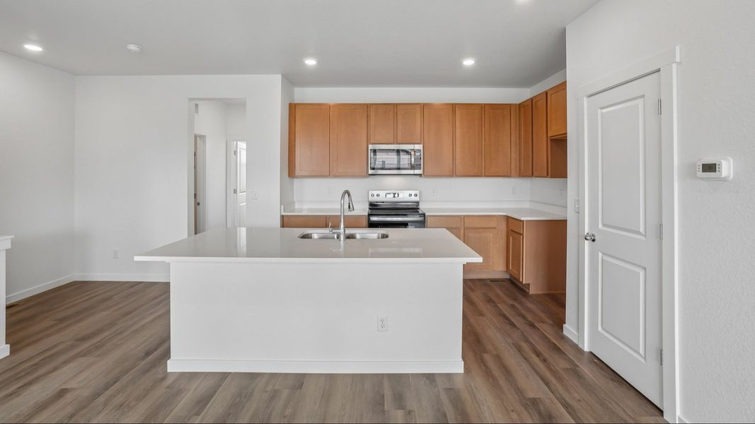 Kitchen with cabinetry, countertops, island, and modern finishes. Kitchen with cabinetry, countertops, island, and modern finishes.