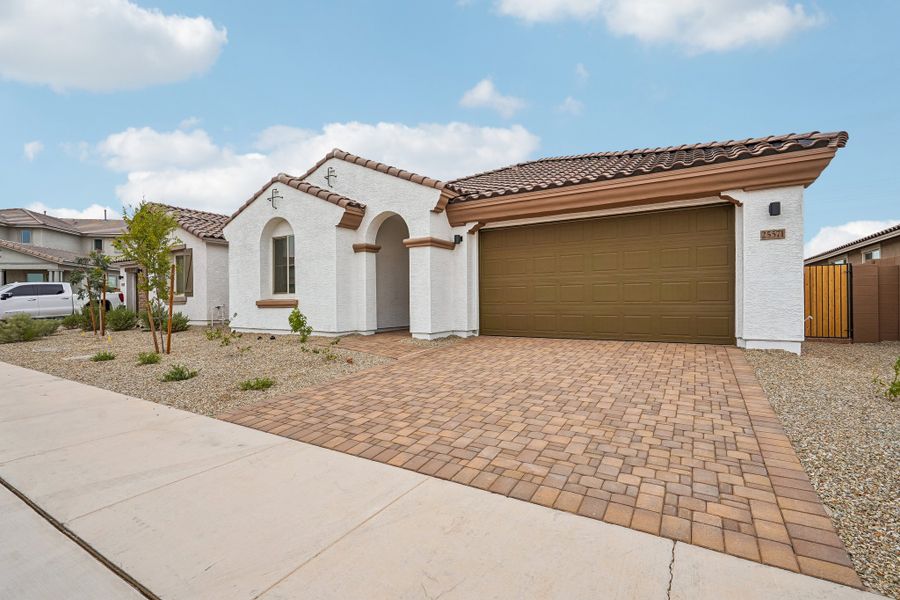 Front exterior of a new home in Rancho Mercado, Surprise, AZ, highlighting curb appeal (Image 25).