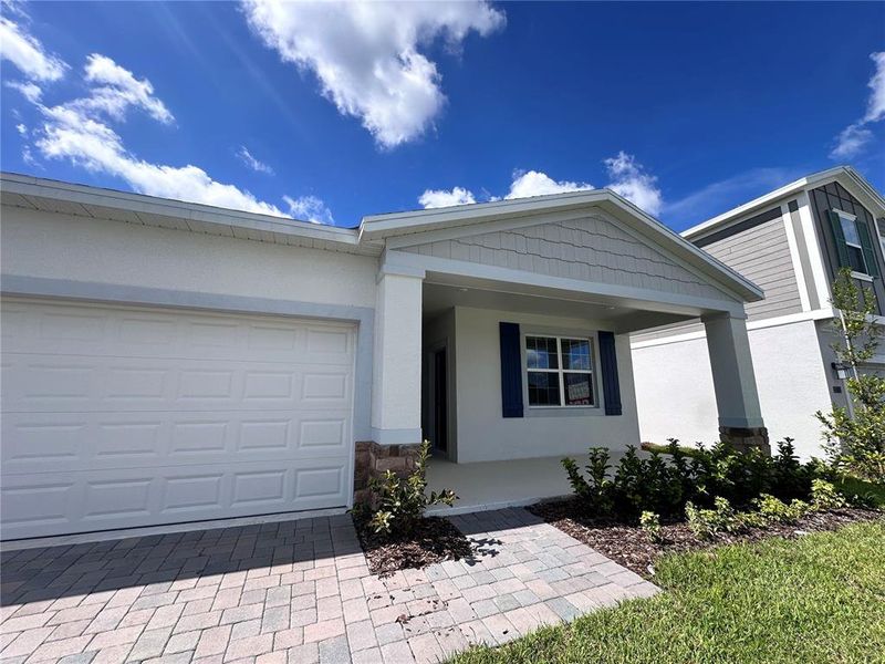 Front exterior of a new home in Bridgewalk, St. Cloud, FL, highlighting curb appeal (Image 2).