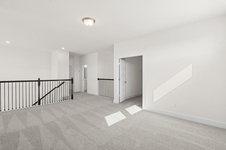 Carpeted spare room featuring baseboards and recessed lighting Carpeted spare room featuring baseboards and recessed lighting