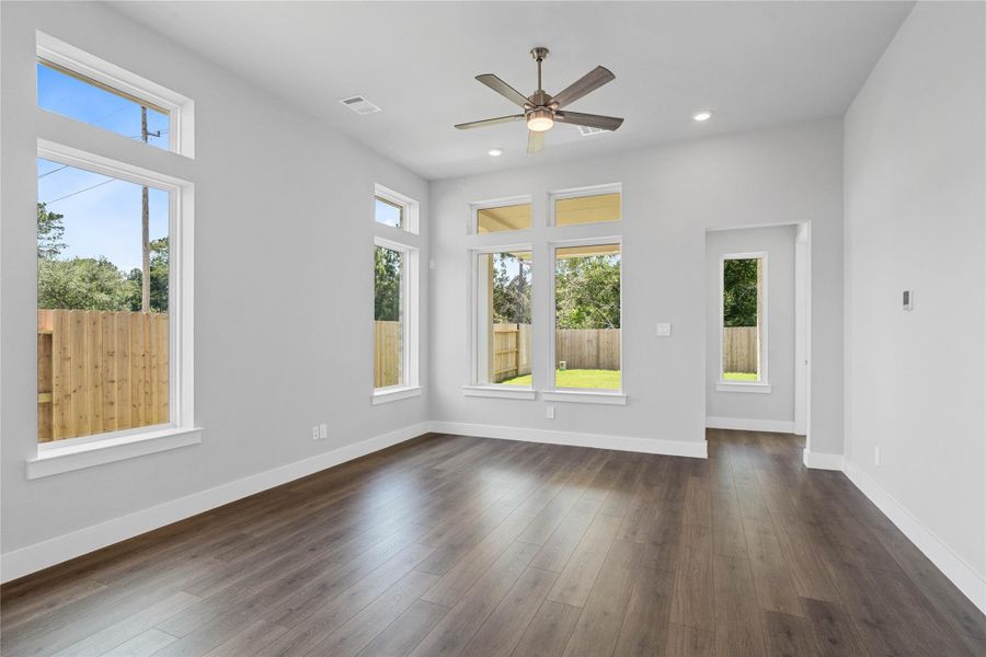 The family room features tall ceilings, ceiling fan, abundant natural light, and an open, inviting ambiance--perfect for gatherings, relaxation, and making memories. The family room features tall ceilings, ceiling fan, abundant natural light, and an open, inviting ambiance--perfect for gatherings, relaxation, and making memories.