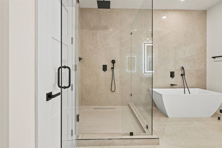 Bathroom featuring plus walk in shower and tile walls