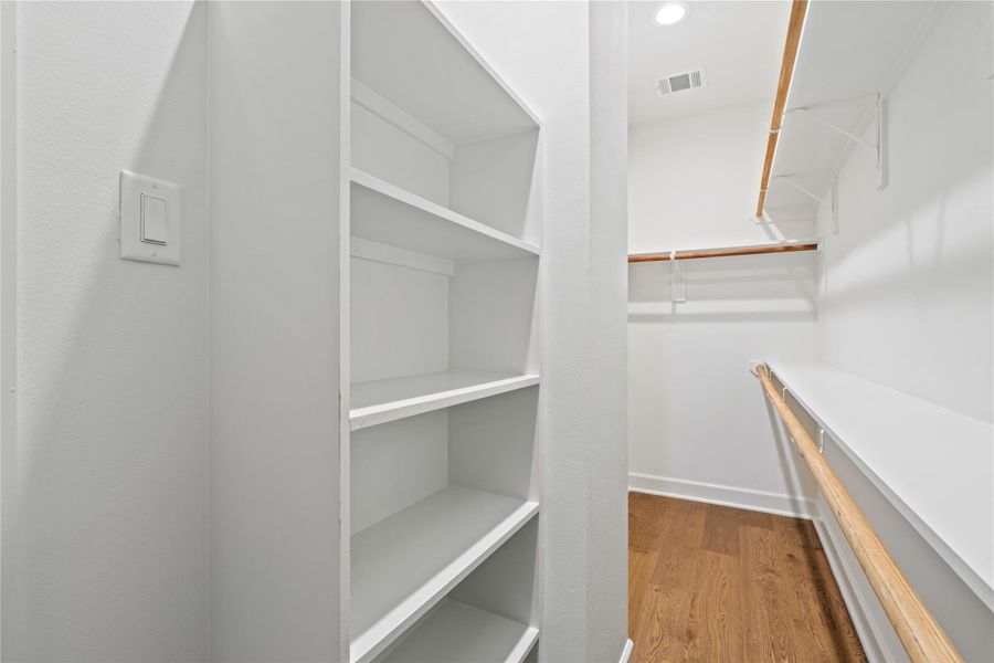 The secondary closet in the primary suite creates true his-and-hers separation for added convenience.