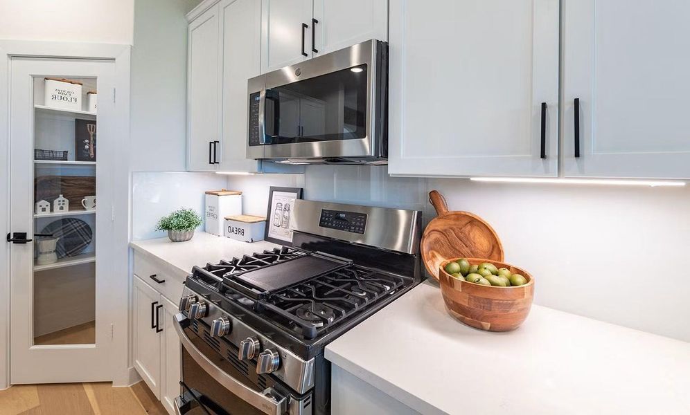 A closer look at this lovely gourmet kitchen highlights the granite countertops, gas cooking, stainless steel appliances, and clean shaker style cabinetry, creating a beautiful and functional space for everyday meals, home cooking, and gathering with those you love. **Photos are representative only and may vary as built.**