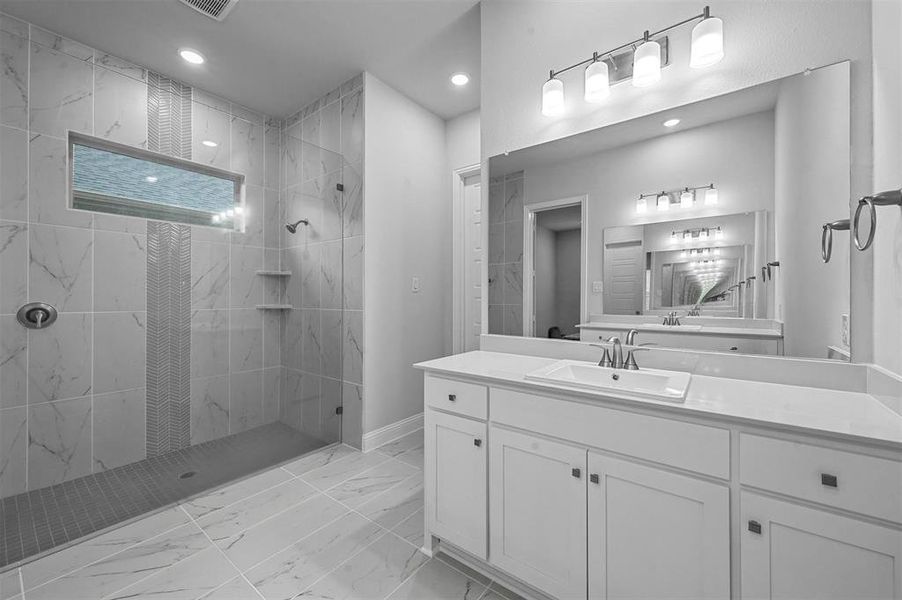Full bath with walk in shower, vanity, light marble finish floors, and recessed lighting
