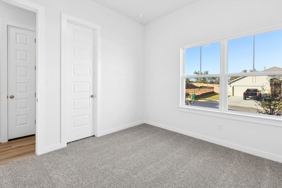 Spacious, unfurnished interior of a new home in The Colony, Bastrop (Image 27).