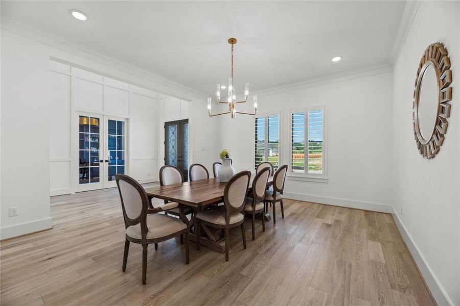 To the left of the entry is your formal dining space, luxury fixtures and beautiful flooring. This spacious dining room is perfect for entertaining.