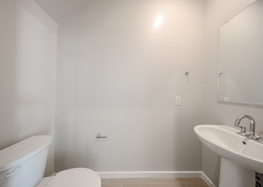 A bathroom with a sink and toilet.