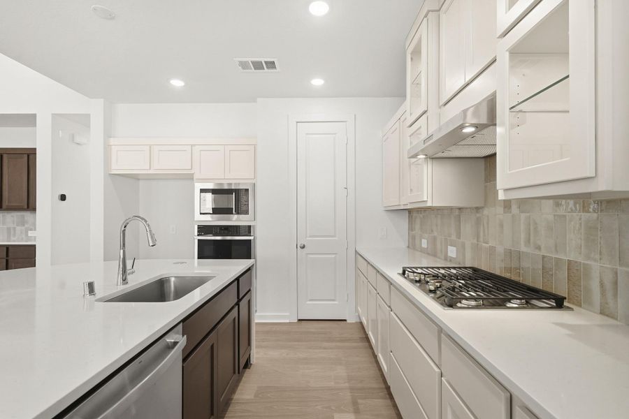A spacious kitchen designed to gather and entertain, featuring an open layout perfect for cooking, dining, and connection. A spacious kitchen designed to gather and entertain, featuring an open layout perfect for cooking, dining, and connection.