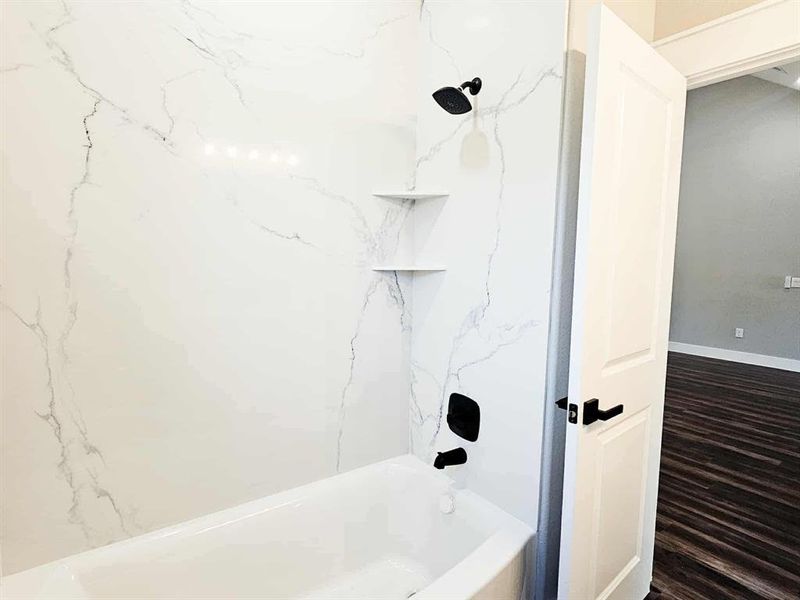 Custom quartz shower and tub in guest bath.