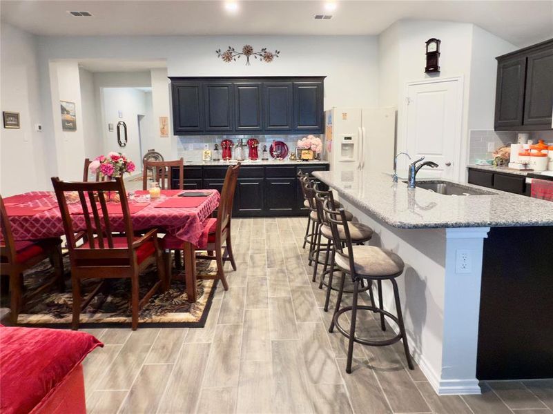 Dining area featuring wood tiled floors Dining area featuring wood tiled floors