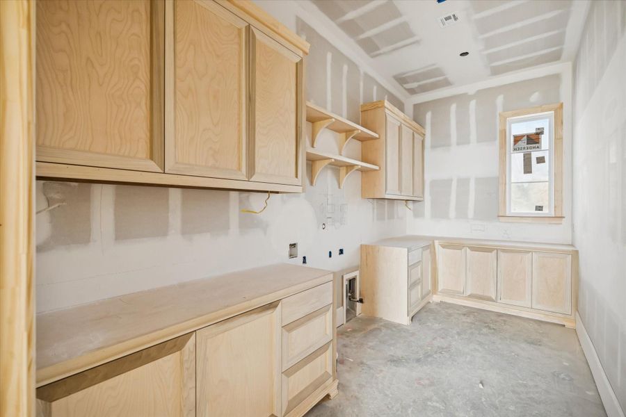 The utility room offers extensive cabinetry, full-extension soft-close drawers, and generous counter space for laundry, storage, and everyday organization. Dedicated zones for appliances and workspace make the room highly functional. A well-planned utility area that keeps the home running smoothly behind the scenes.